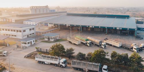 aerial view factory trucks parked near warehouse daytime transformed